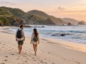 Travelers following a mawi beach sunrise guide beside the bay in soft morning light